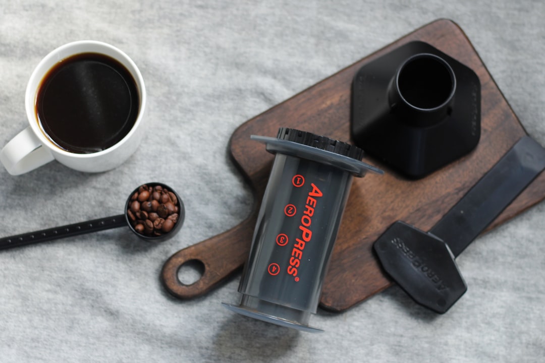AeroPress standard method brewing with aggressive stirring spoon creating a dark vortex in the chamber