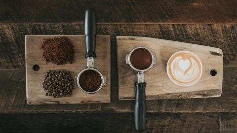 Close-up of a pour-over coffee cup showing dark, bitter-looking liquid next to a lighter, diluted cup, illustrating the concept of bitterness not over-extraction.