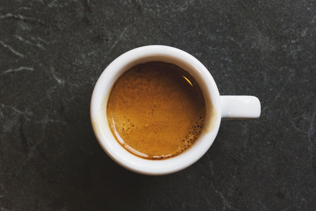 Overfilled 14g espresso basket showing coffee touching the shower screen, causing channeling
