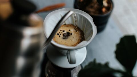 Ceramic pour over coffee dripper on kitchen counter next to burr grinder