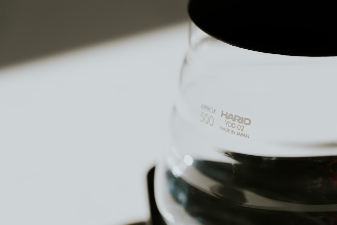 Close-up of a Hario Switch brewer with coffee grounds and water, highlighting the dual-path design for brewing.