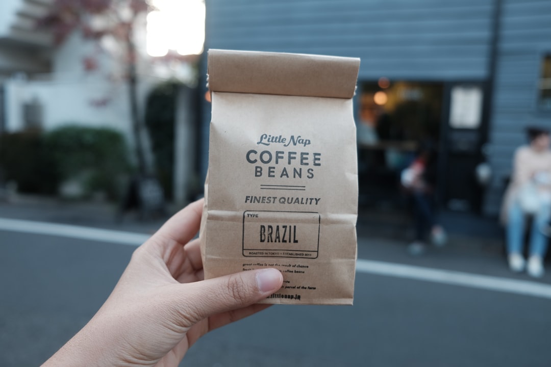 A close-up of a coffee bag with tasting notes like 'blackberry jam' next to a brewed cup of coffee, illustrating the disconnect between marketing and reality.