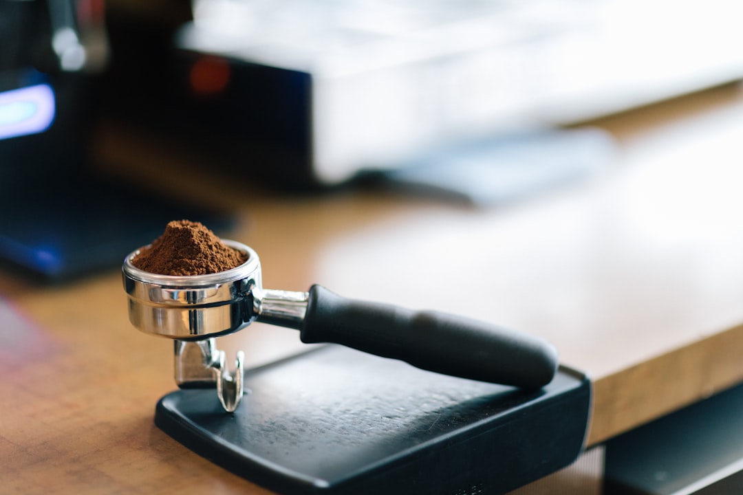 A wet, soggy espresso puck sitting in a portafilter basket, showing signs of channeling and low pressure extraction